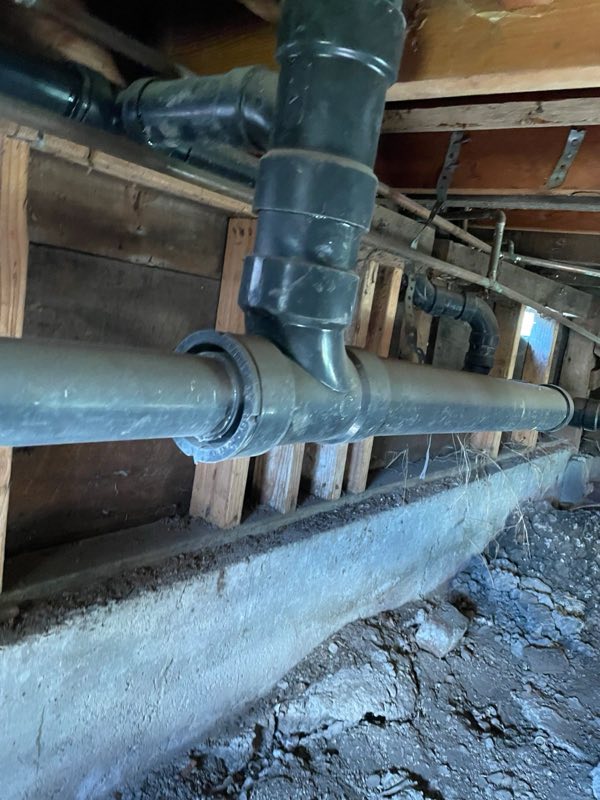 Old cast iron drain line under a house