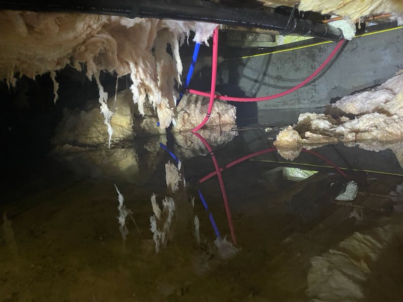 Standing water in a crawlspace before repair