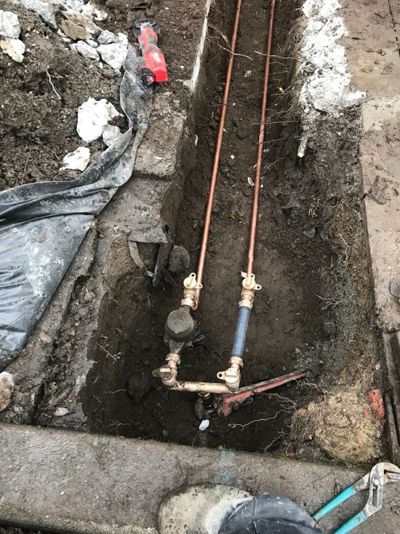 New water line with brass shutoff valves in an open trench